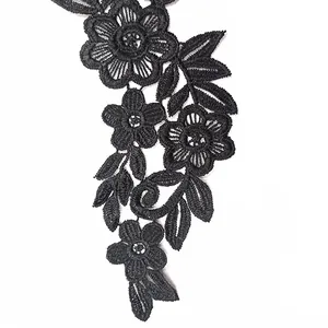 Detailed view of black water-soluble lace floral embroidery with hollow-out design.