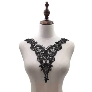 Detail of black water-soluble lace floral embroidery collar on a mannequin torso