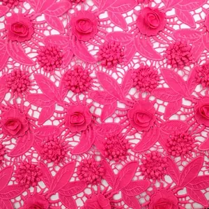 Close-up of magenta 3D hollow-out milk silk embroidery lace fabric with rose appliques