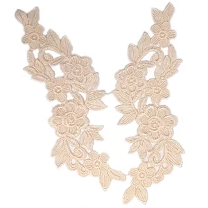 Detail view of symmetrical beige water-soluble lace floral appliques for DIY crafts