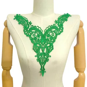 Detailed view of a bright green water-soluble lace embroidery collar on a white mannequin