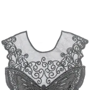 Detailed close-up of grey water-soluble lace embroidery with butterfly and swirl patterns