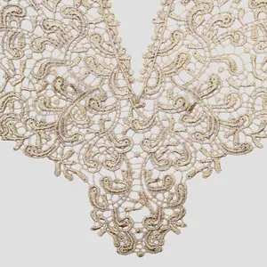 Detailaufnahme einer beige wasserlöslichen Spitze mit aufwendigen floralen Hohlmustern