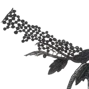 Close-up detail of black water-soluble lace embroidery patch with intricate floral patterns