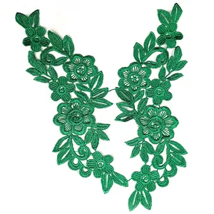 Detailed macro view of green water-soluble embroidered floral lace patches for DIY