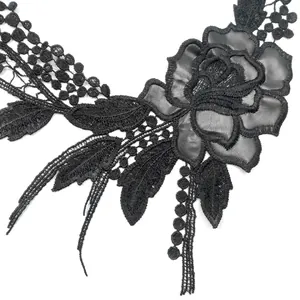 Detailed close-up of intricate black floral lace applique with PU leather rose petal inserts