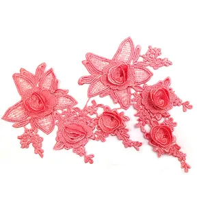 Close-up macro view of pink 3D embroidered floral water-soluble lace applique for DIY sewing