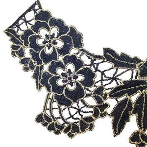 Detailed close-up of black and gold embroidered water-soluble lace collar applique