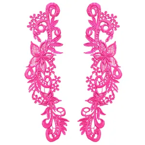 Detailed view of a pair of fuchsia water-soluble floral lace appliques for DIY sewing