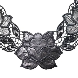 Close-up detail of black water-soluble lace collar with PU leather floral embroidery