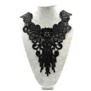Detail view of an elegant black water-soluble lace collar with 3D floral embroidery.