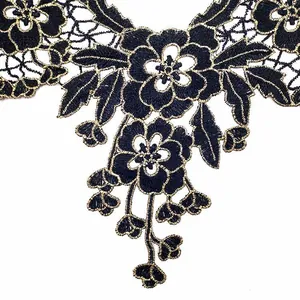 Close-up detail of black and gold embroidered lace collar patch with hollow flowers