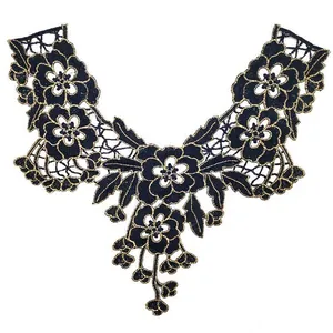 Detailed view of heavy work black and gold water-soluble lace floral collar applique