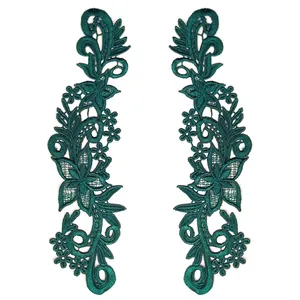 Close-up detail of dark green water-soluble lace floral embroidery appliques for DIY sewing