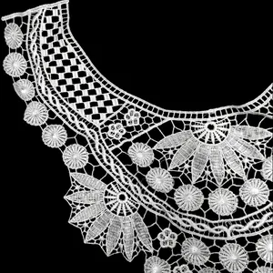 Macro view of white water soluble lace collar with intricate 3D floral embroidery