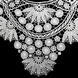 Detailed macro view of white water-soluble lace floral embroidery collar applique