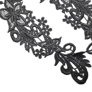 Close-up view of black water-soluble floral lace applique with detailed embroidery texture
