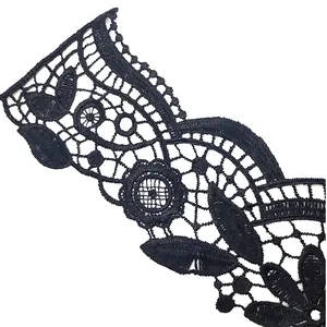 Detailed macro view of black water-soluble lace embroidery with intricate floral patterns