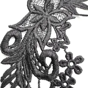 Detailed view of black water-soluble lace embroidery with intricate floral patterns