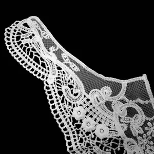 Detailed close-up of white milk silk embroidered lace collar with hollow-out floral patterns