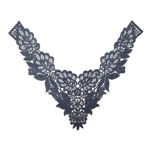 Detailed macro shot of navy blue water-soluble lace embroidered floral collar applique