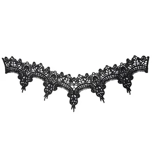 Close-up detail of a delicate black water-soluble lace embroidery neckline appliqué patch