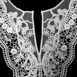 Close-up detail of white milk silk water-soluble lace collar with floral embroidery