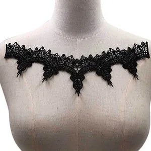 Macro view of black water-soluble lace embroidery patch with intricate hollow-out floral pattern