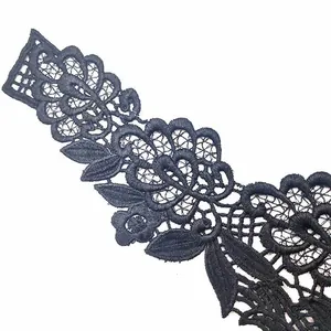 Macro view showing the intricate detail of black water-soluble lace embroidery flower