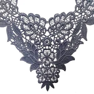 Close-up of black water-soluble lace embroidery with intricate hollow-out floral patterns.