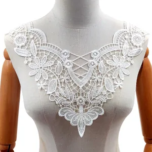 Detailed macro view of white water-soluble lace embroidered flower collar on mannequin