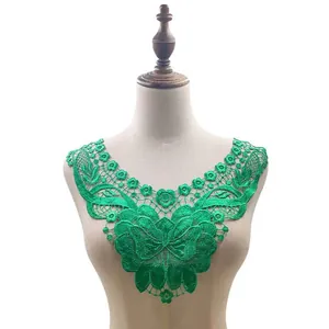 Detailed macro view of green water-soluble lace collar with 3D floral embroidery on mannequin