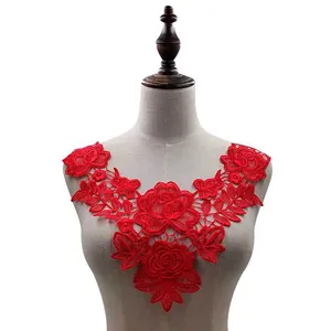Close-up detail of a red water-soluble floral lace collar applique on a mannequin