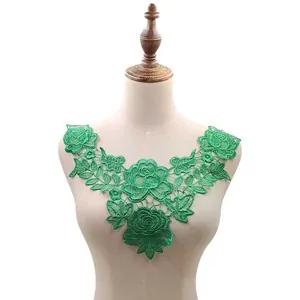 Detailed view of bright green water-soluble floral lace collar on clothing mannequin torso