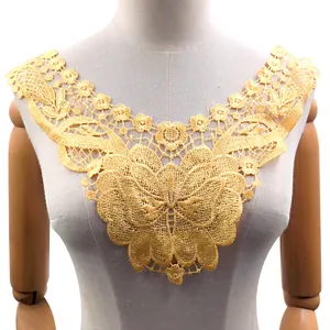 Detailed view of intricate yellow water-soluble lace collar with floral embroidery