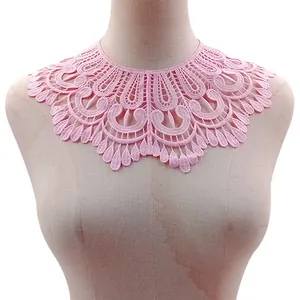 Dettaglio del colletto in pizzo rosa con ricamo in seta di latte su un manichino.