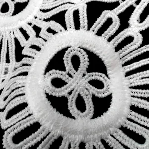 Detailed macro view of white water-soluble milk silk lace collar with hollow embroidery