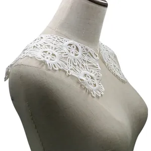 Detailed view of a white hollow embroidered water-soluble lace collar on a mannequin