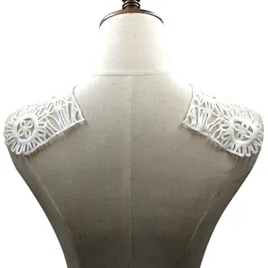 Detail view of white water-soluble milk silk lace appliques on a mannequin shoulder
