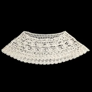 Close-up view of off-white lace hollow-out shawl with intricate floral patterns