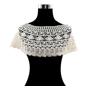 Detailed macro view showing the intricate white floral lace crochet of a hollow-out shawl
