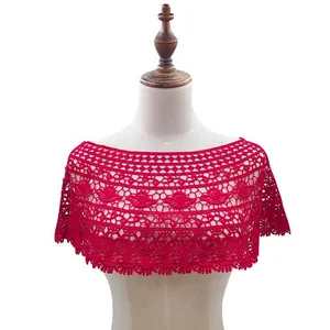 Detailed view of red crochet lace shawl with intricate hollow-out floral patterns