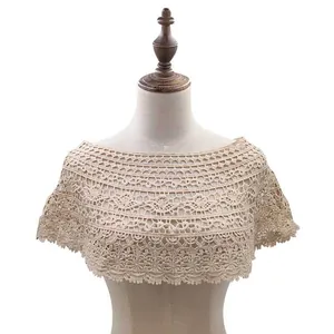 Detailed view of a vintage style beige crochet lace hollow-out shawl on mannequin