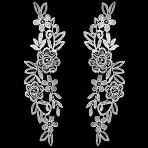Detailed view of white water-soluble lace floral embroidery patches for DIY craft accessories.