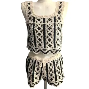 Detailed view of cream and black crochet knit tank top and shorts set on mannequin