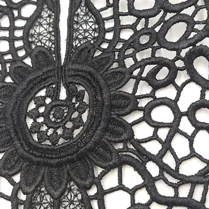Detailed macro shot showing the texture of intricate black floral lace hollow embroidery