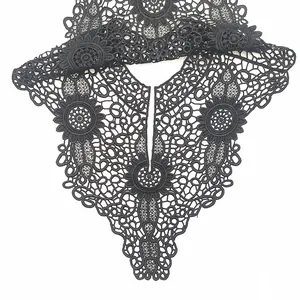 Close-up detail of the intricate black hollow-out floral lace embroidery on a false collar.