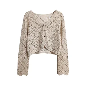 Front view detail of a bohemian cream crochet hollow-out cropped cardigan jacket