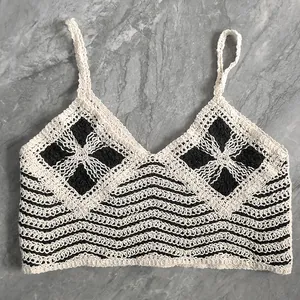 Close-up detail of handmade crochet knit camisole with black and white pattern