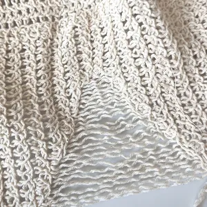 Gros plan de la maille crochetée crème rétro avec des détails de franges ajourées